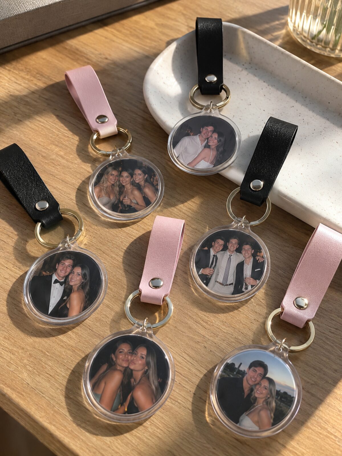 Personalised photo keychains on black and blush leather straps, assembled live at an Adelaide event